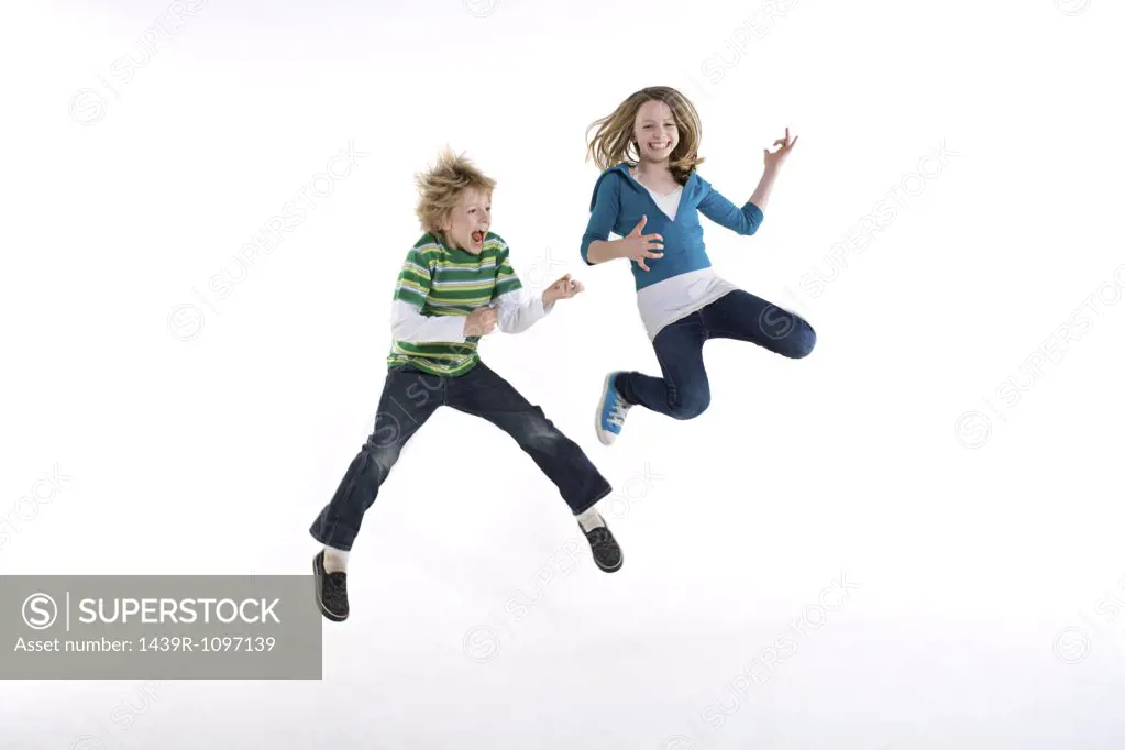 A boy and girl jumping