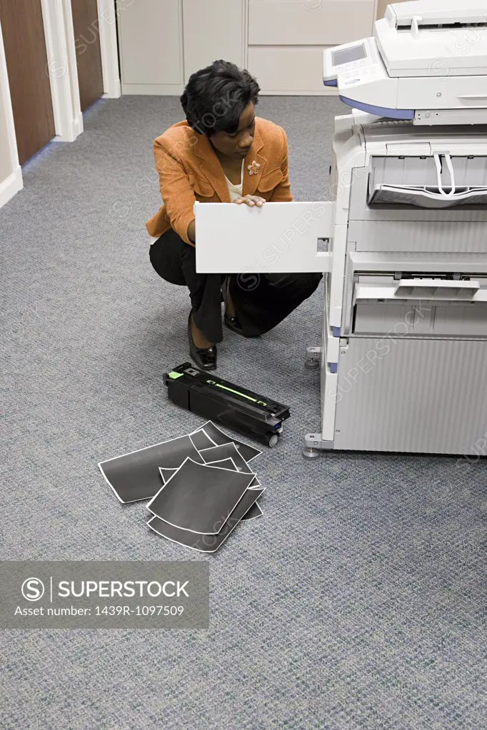 Office worker looking at photocopier
