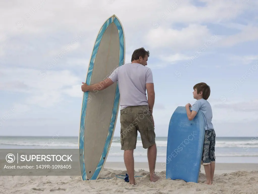 Father and son with surfboard and bodyboard