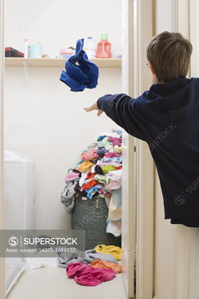 A boy throwing his laundry