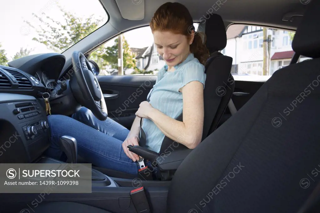 A woman fastening a seatbelt