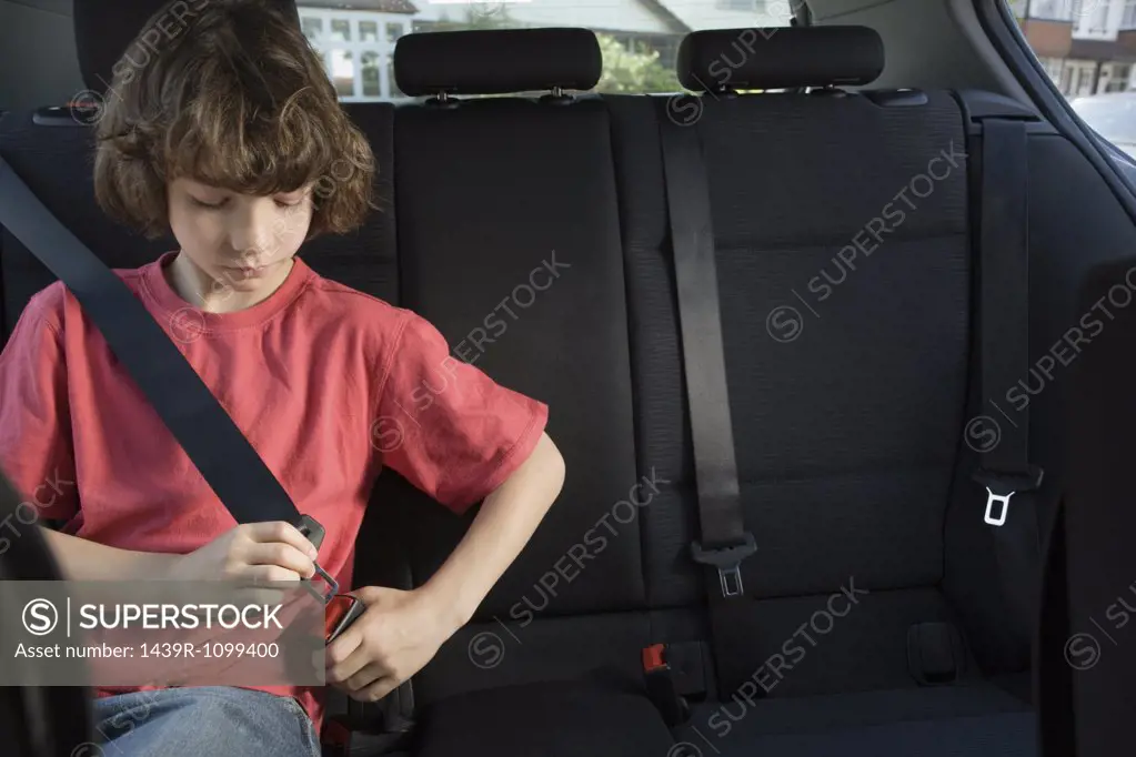 Boy fastening his seatbelt