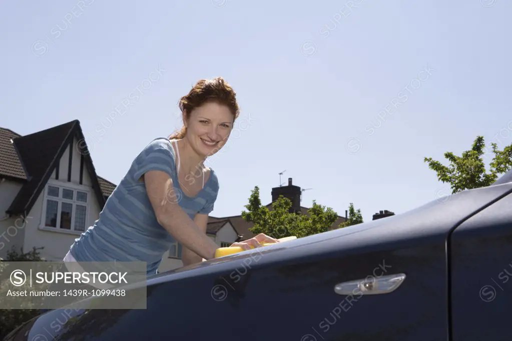 A woman washing a car