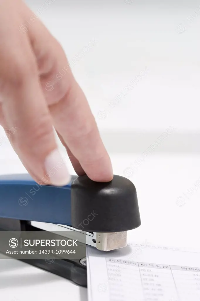 Person using stapler