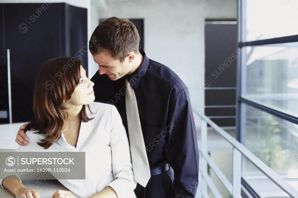 Man and woman cuddling in office