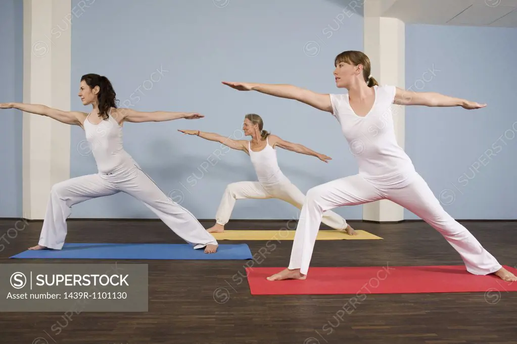 Three women practising yoga