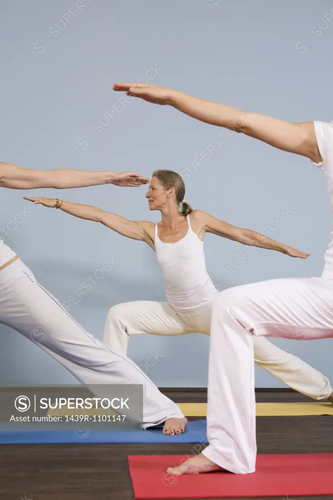 Three women practising yoga