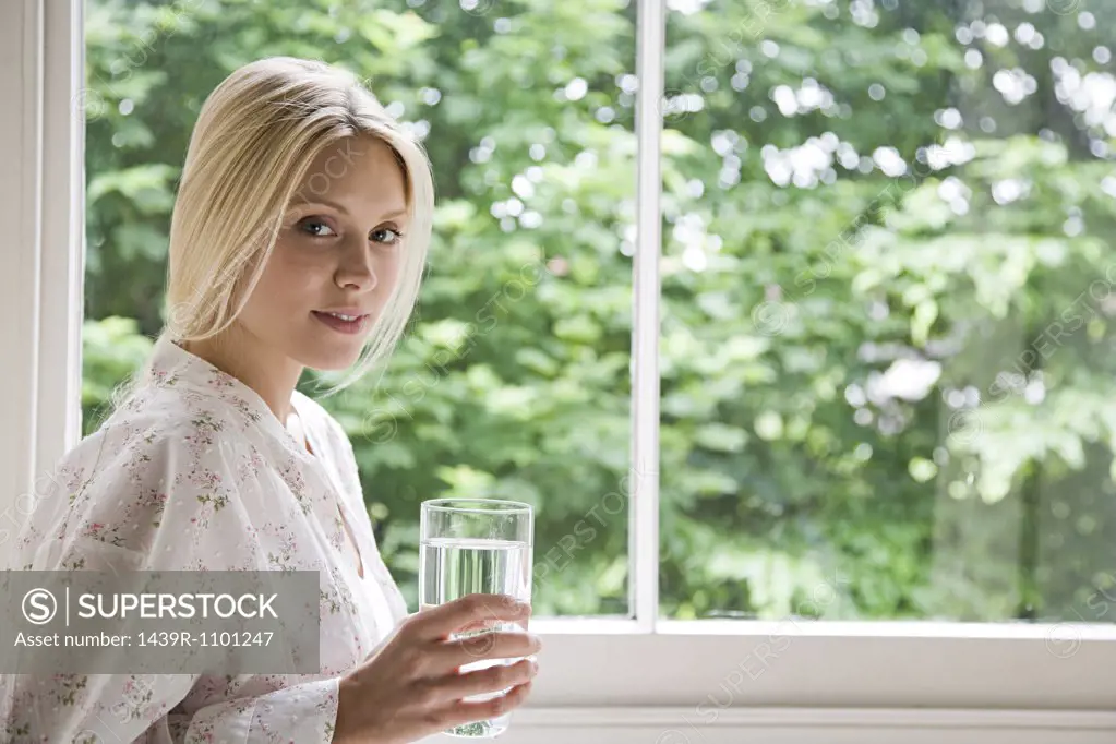 Young woman with glass of water