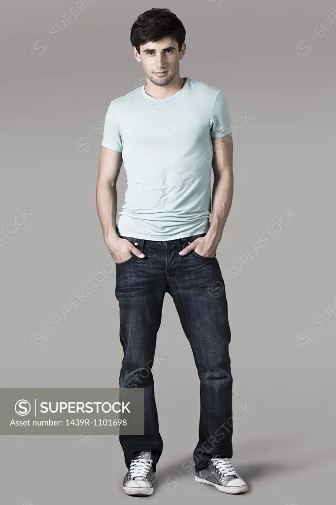 Studio shot of a man with his hands in his pockets