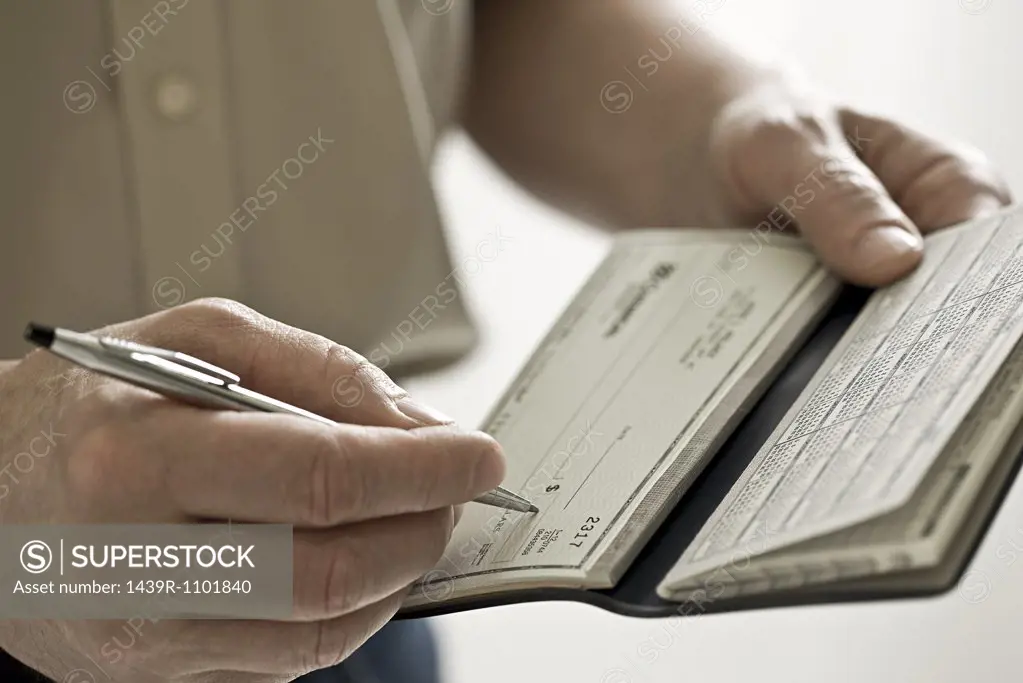 A man holding a cheque book