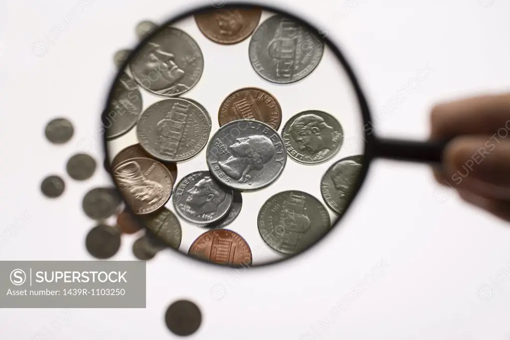 Coins and magnifying glass