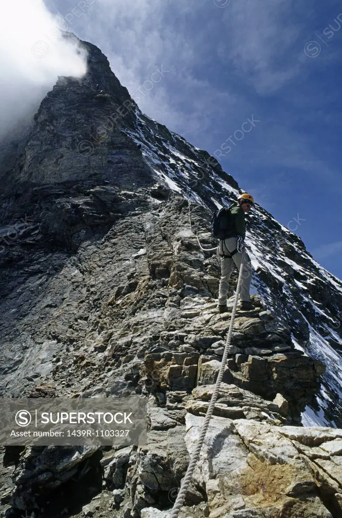 Climber descending hornli ridge on matterhorn