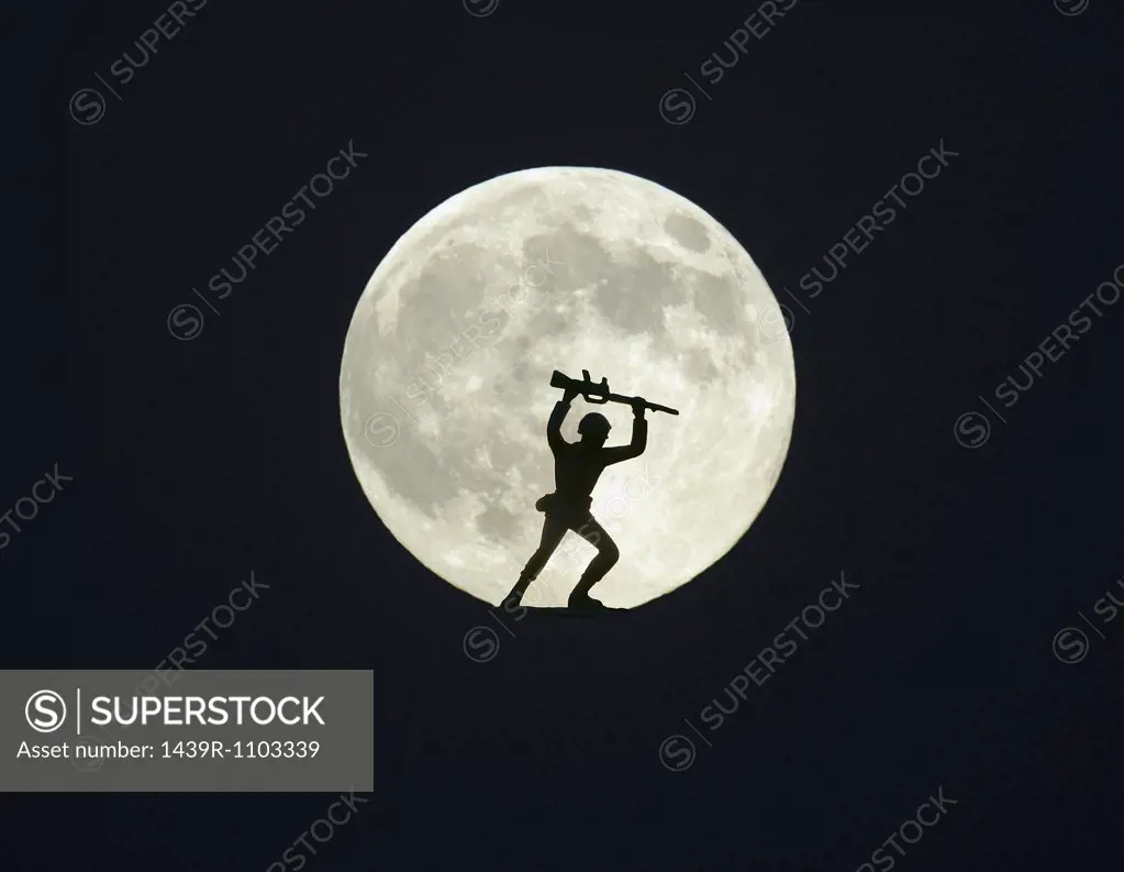 Toy soldier against full moon
