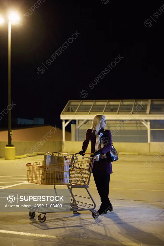 Woman alone in supermarket parking lot