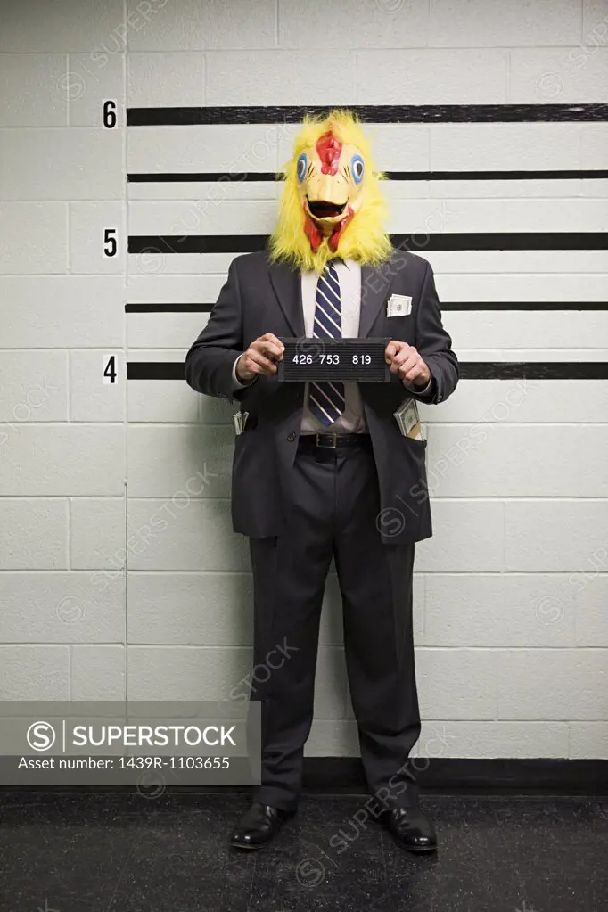 Mugshot of businessman with chicken head