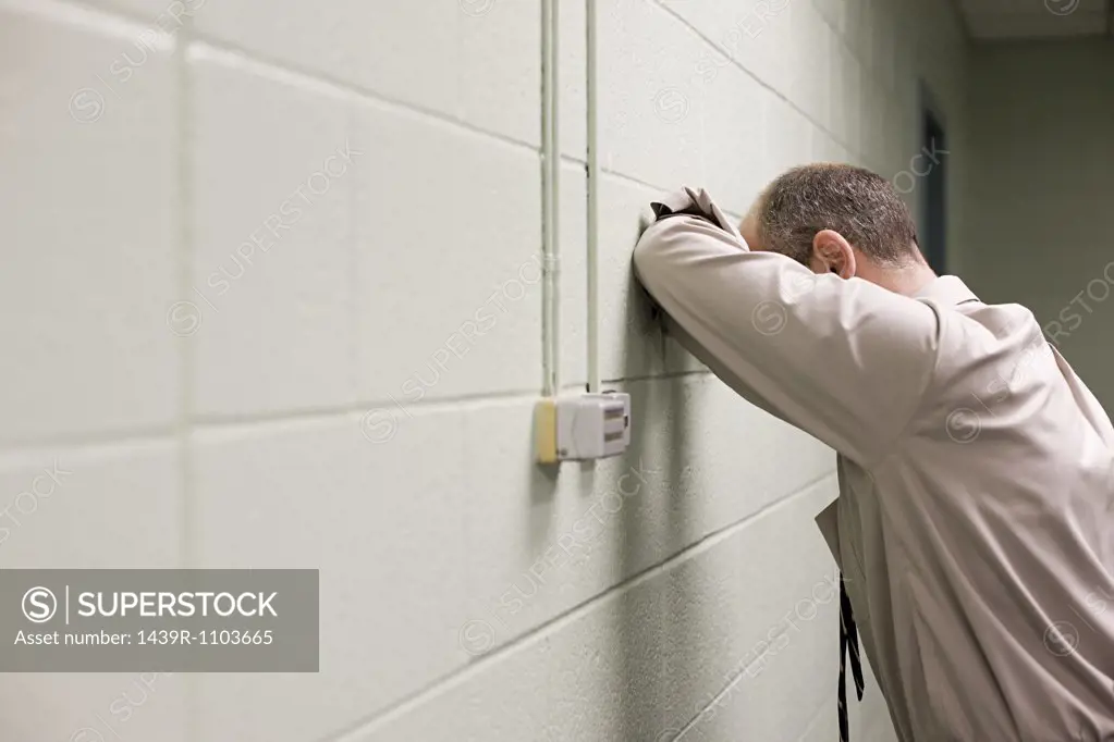 Man leaning on wall