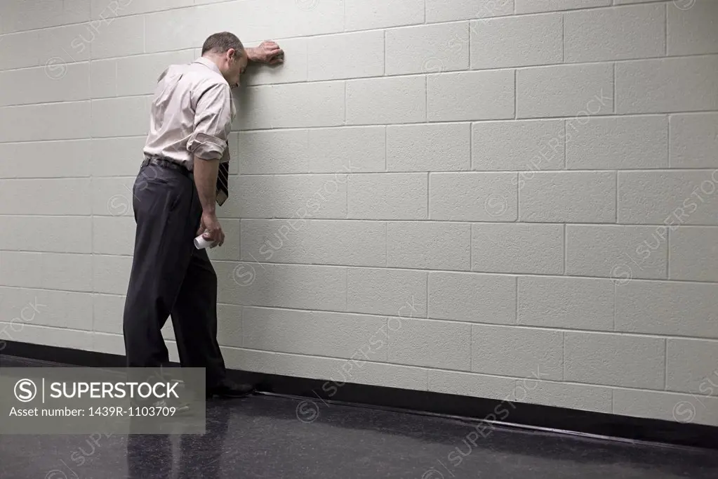 Man leaning against wall