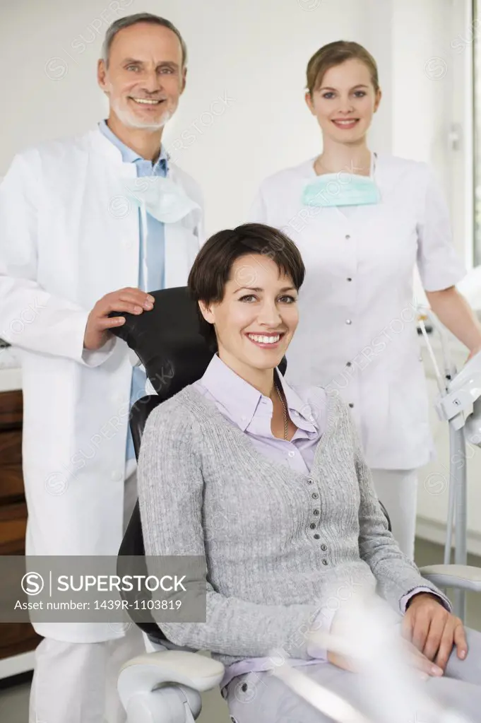 Woman at with dentist and hygienist