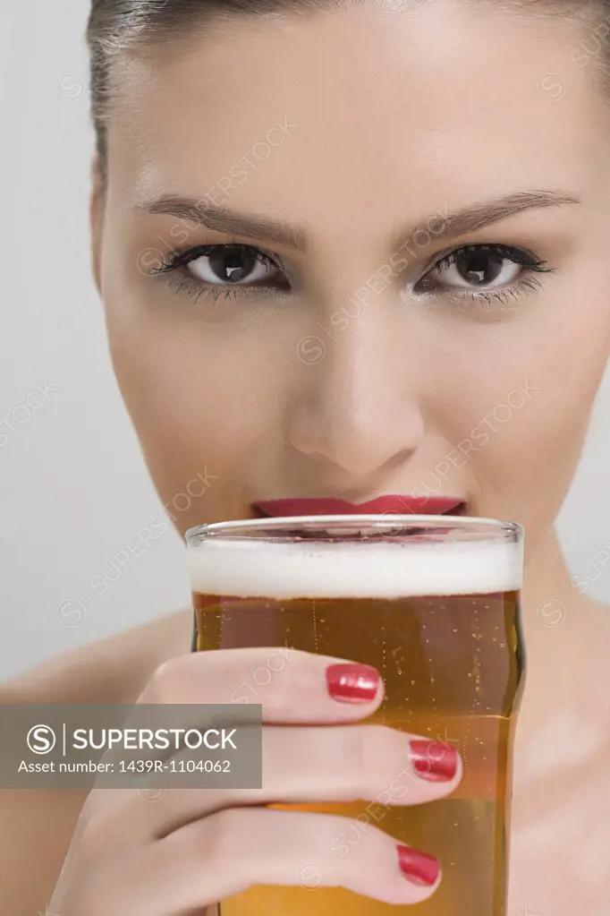 Woman drinking a pint of lager