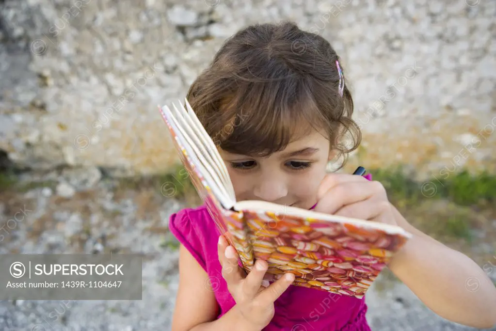 A girl writing in a book