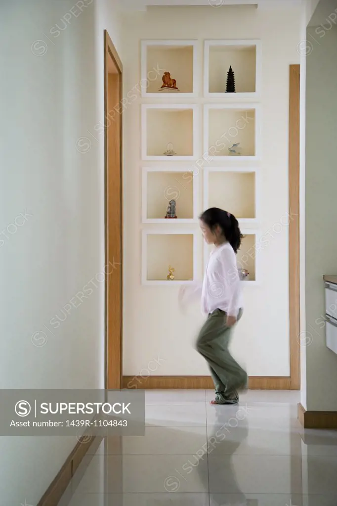 A girl walking in a corridor