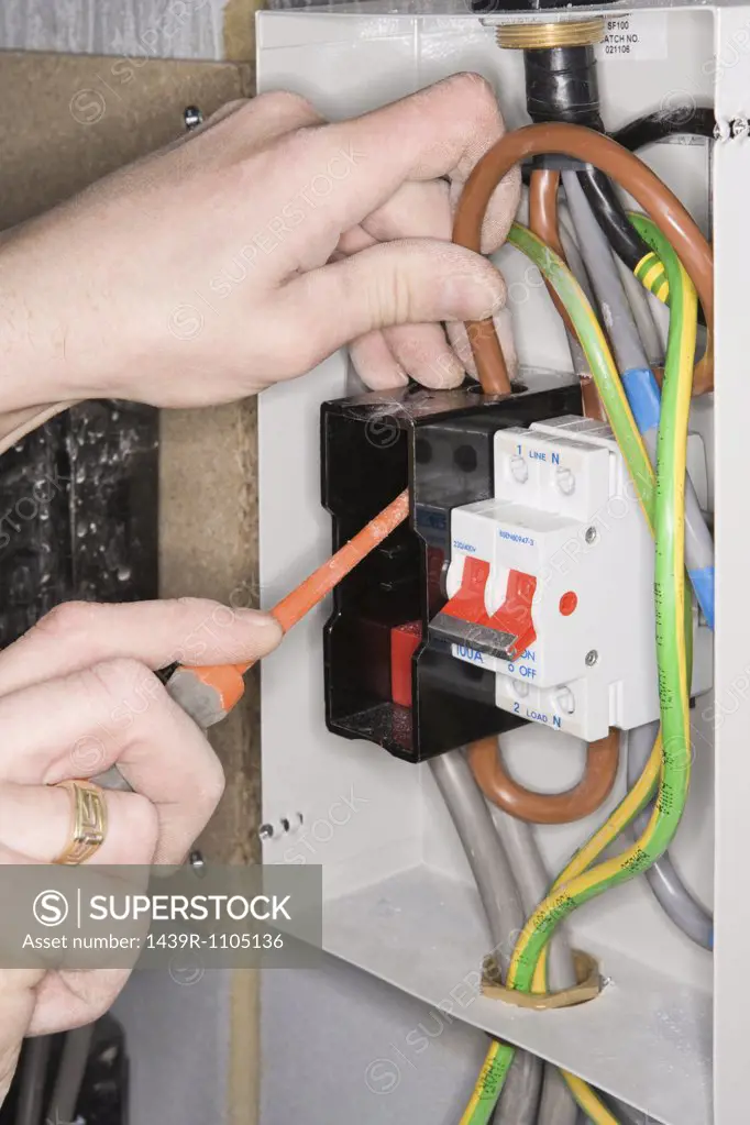An electrician fixing a fuse box