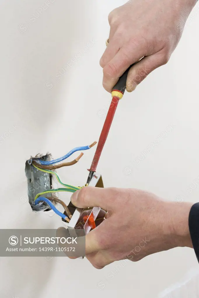 An electrician fixing a socket