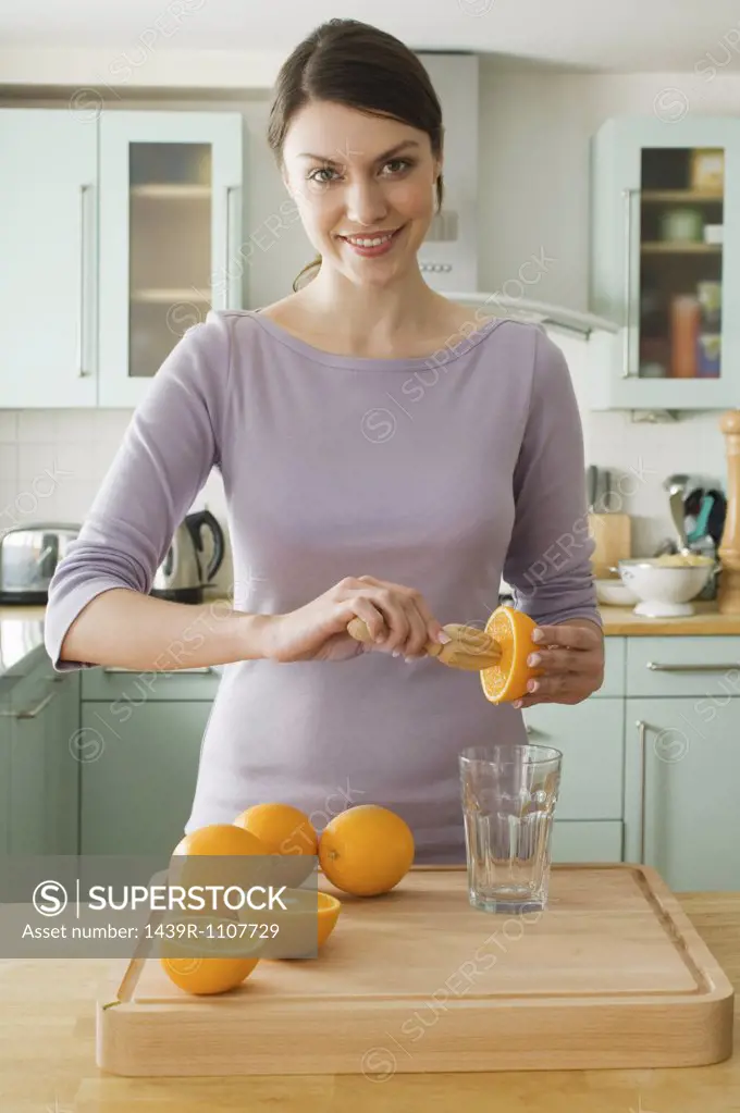 Woman making orange juice