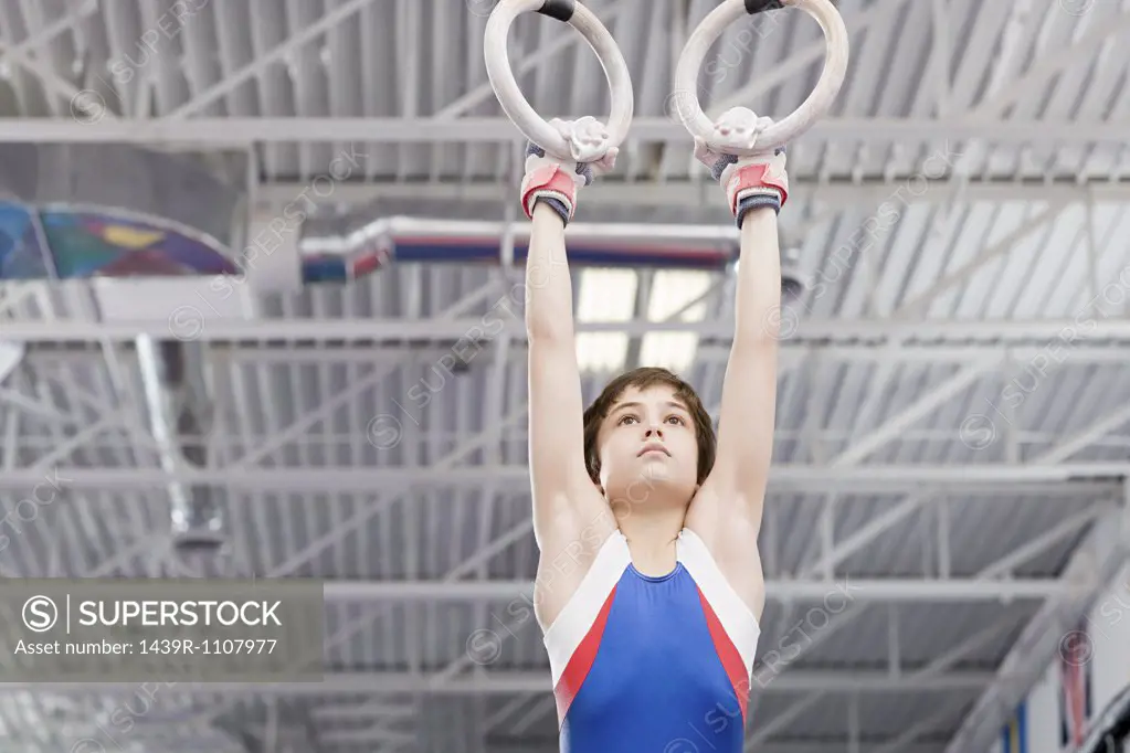 Gymnast hanging from a gymnastic ring