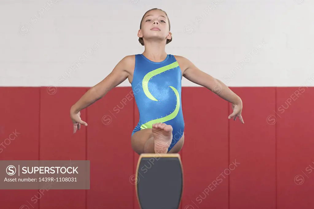 Gymnast doing the splits on a balance beam