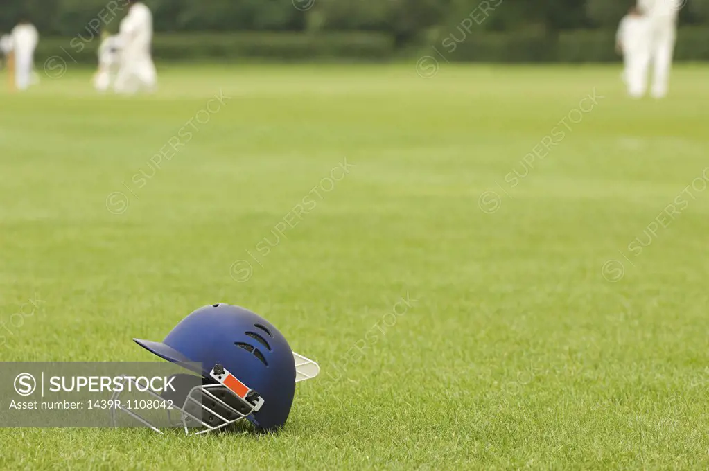 Cricket helmet on a cricket ground