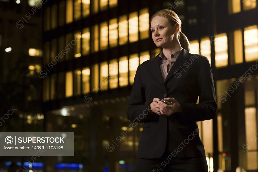 Businesswoman outside an illuminated building