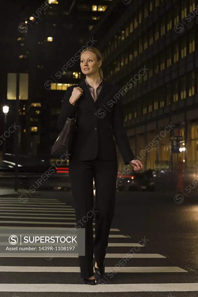 Businesswoman crossing the street