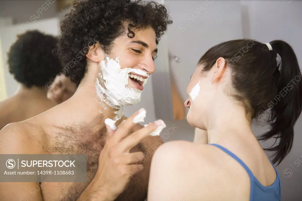 Couple playing with shaving foam