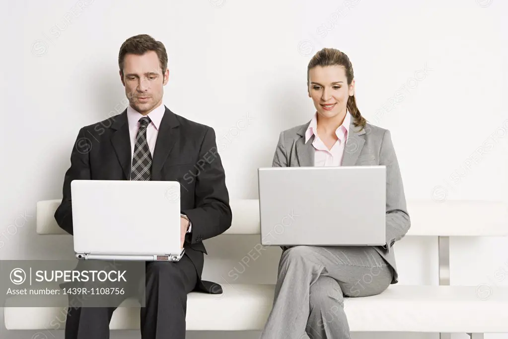 Businesspeople with laptops