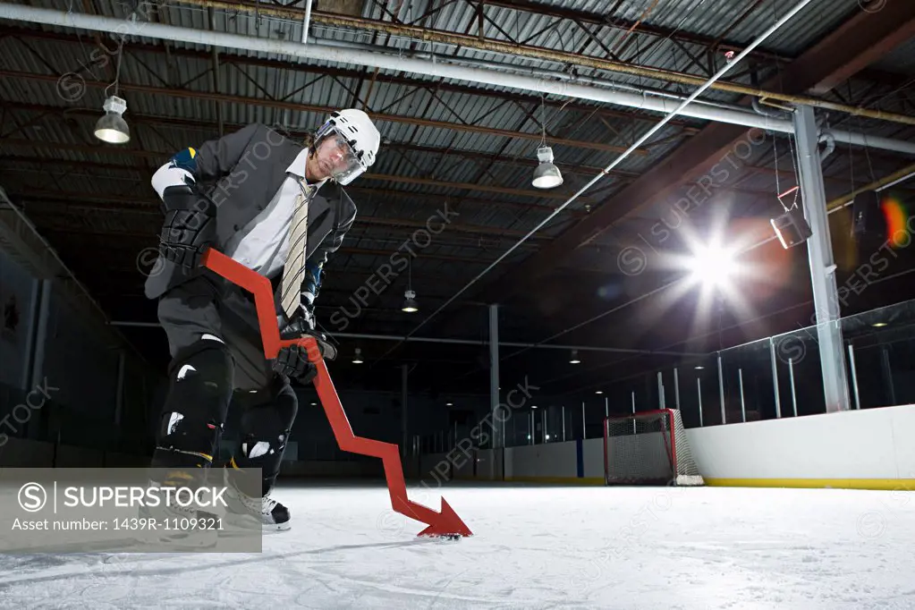 Businessman playing ice hockey