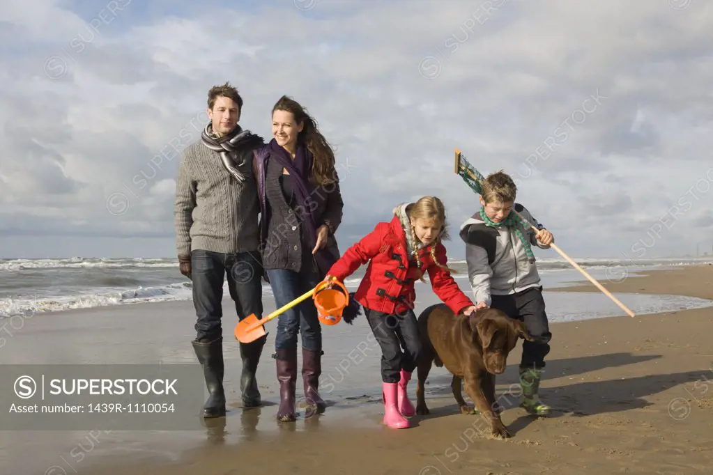 Family and dog by the sea