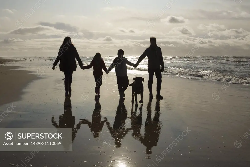 Family and dog by the sea
