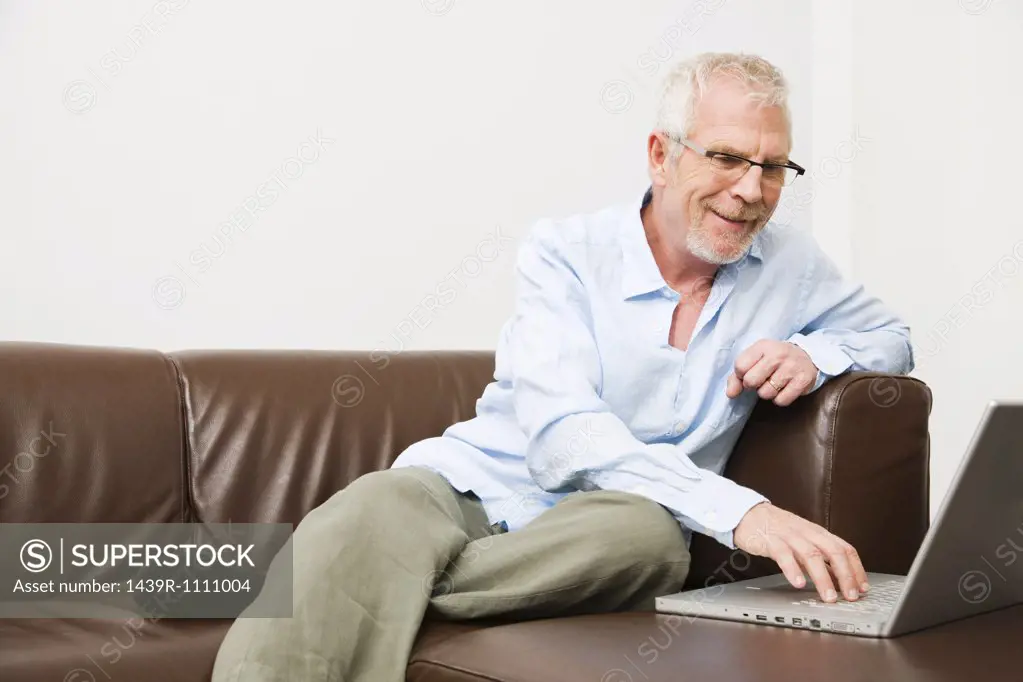 Mature man using laptop