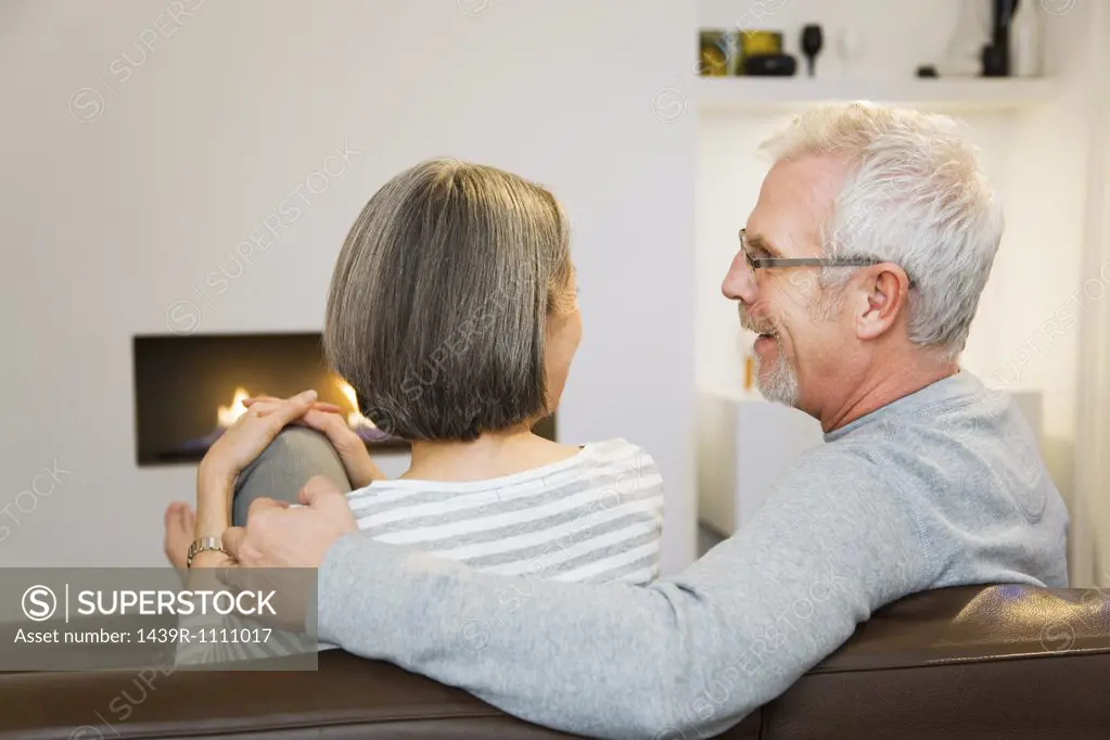 Mature couple sat next to the fire