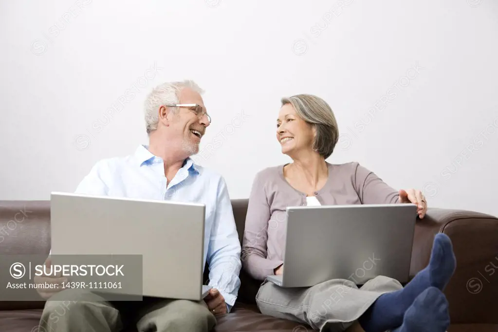 Mature man and woman using a laptop