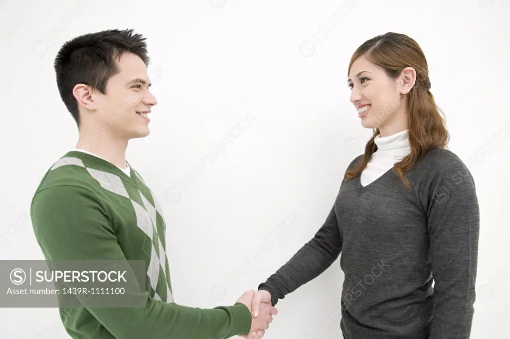 Office workers shaking hands