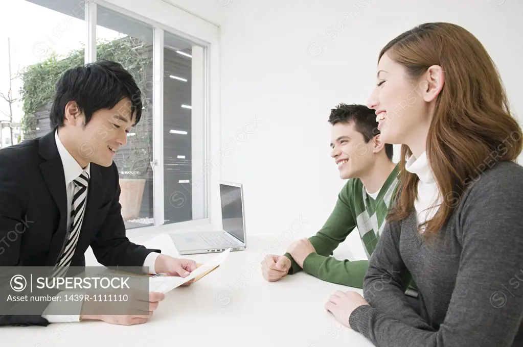 A businessman in a meeting with clients