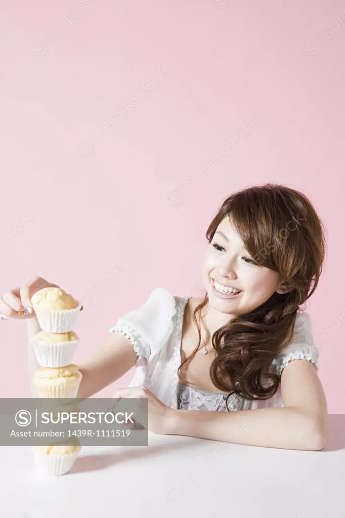 Woman with stack of cakes