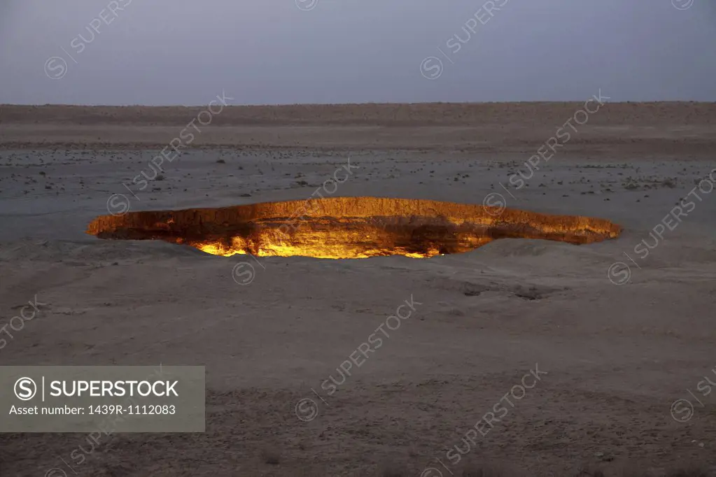 Fire burning in pit in desert