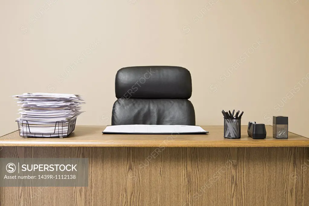 Office desk with overflowing inbox
