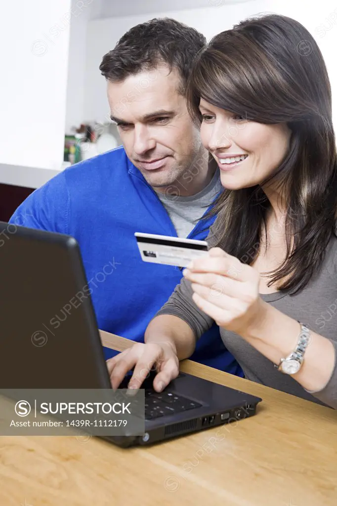 Couple with laptop and credit card