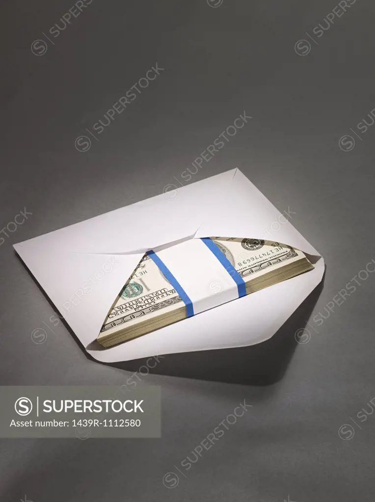 Hundred dollar bills in envelope