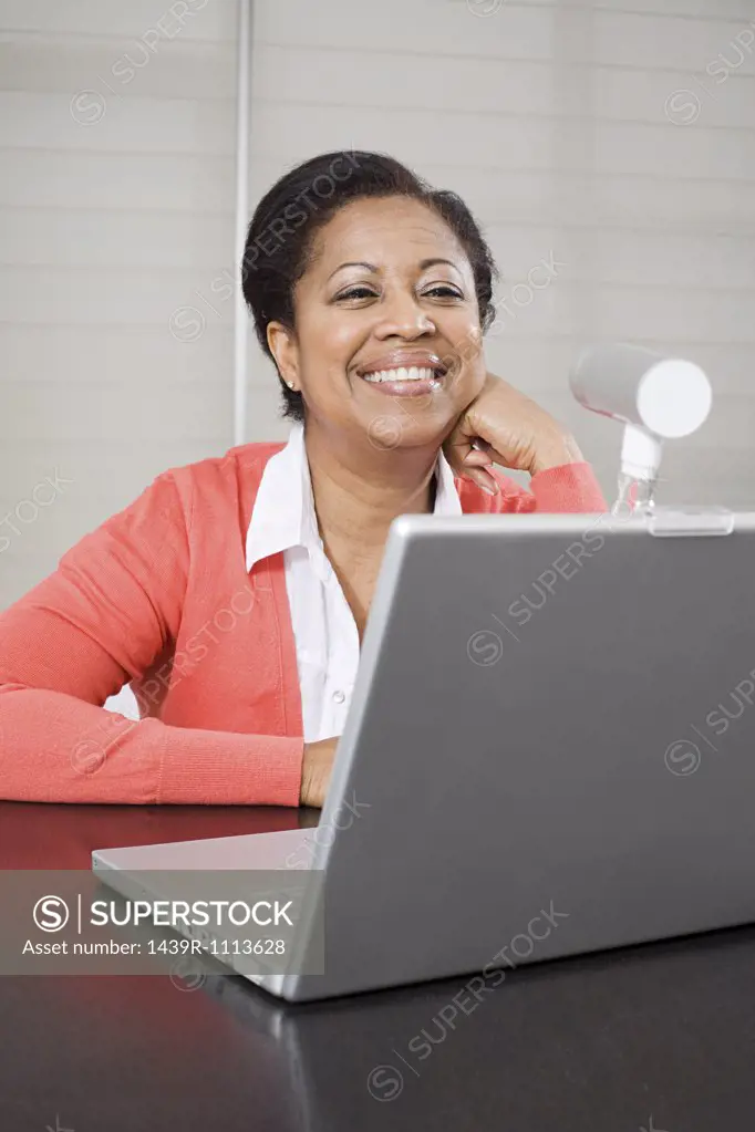 Mature woman using webcam