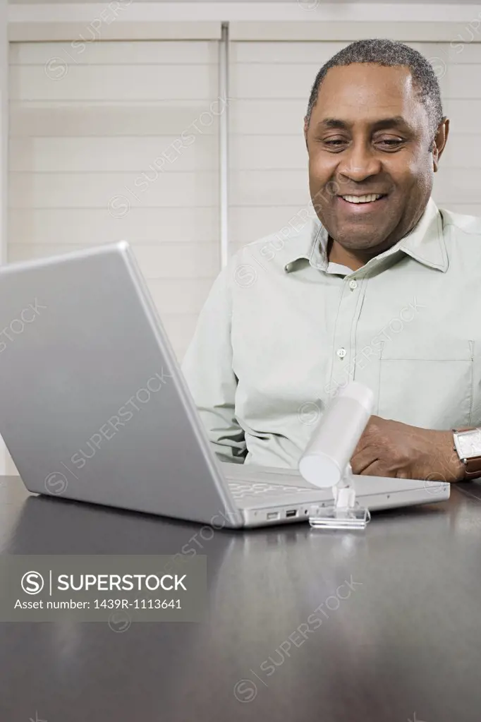Mature man using webcam